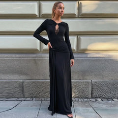 Black long sleeve cutout maxi dress against a building