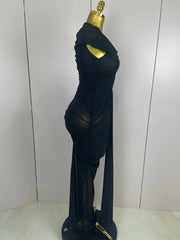 Black evening gown on a mannequin against a plain background