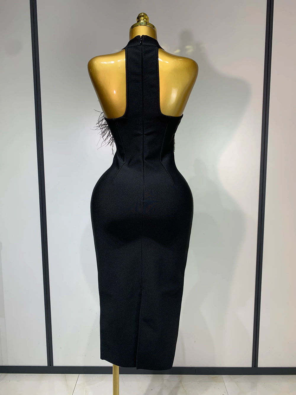 Turtleneck sleeveless diamond and feather embellished midi dress back view.