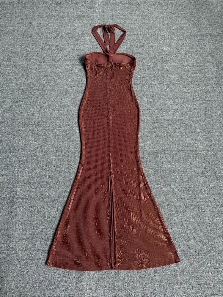 Back view of a sequin strapless maxi dress with a high slit.