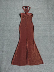 Back view of a sequin strapless maxi dress with a high slit.