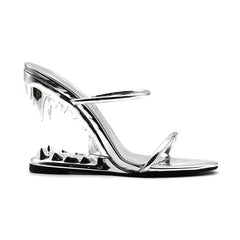 Clear high-heeled sandal with metallic finish on a white background