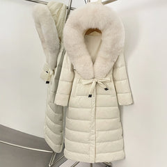 White puffer coat with fur collar on a rack against a white background