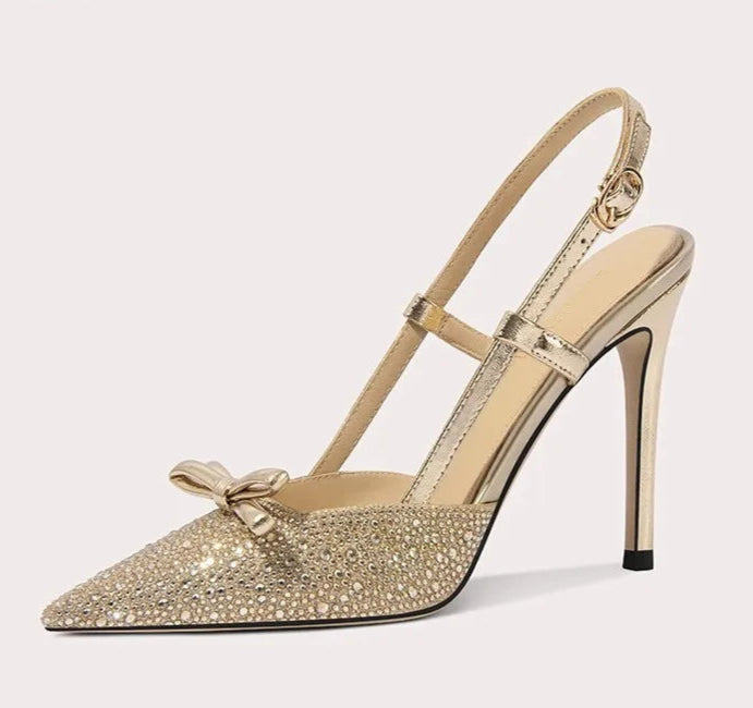 High-heeled shoe with a bow detail on a light gray background