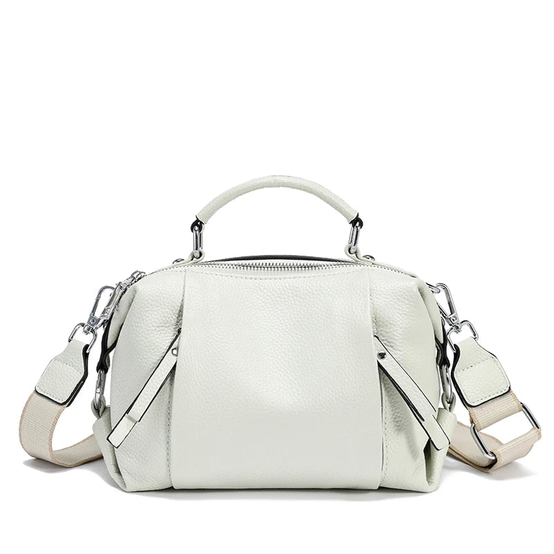 White handbag with a strap on a white background