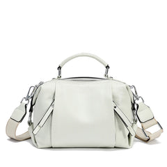 White handbag with a strap on a white background