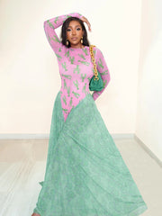 Woman wearing a pink top with cactus pattern and a green skirt, holding a green handbag.