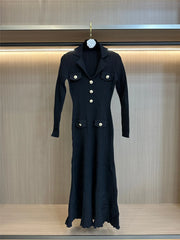 Black coat with white buttons on a hanger against a neutral background