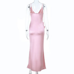 Pink satin slip dress on a mannequin against a white background