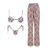 Patterned triangle bikini top and string bikini bottom with black and white striped straps.
