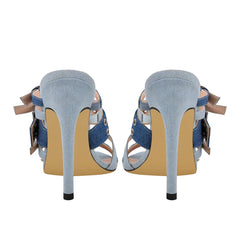 Back view of denim stiletto sandals with tan sole