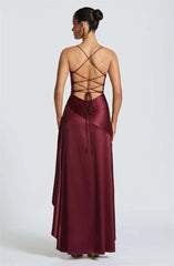Burgundy evening gown with open back on a white background
