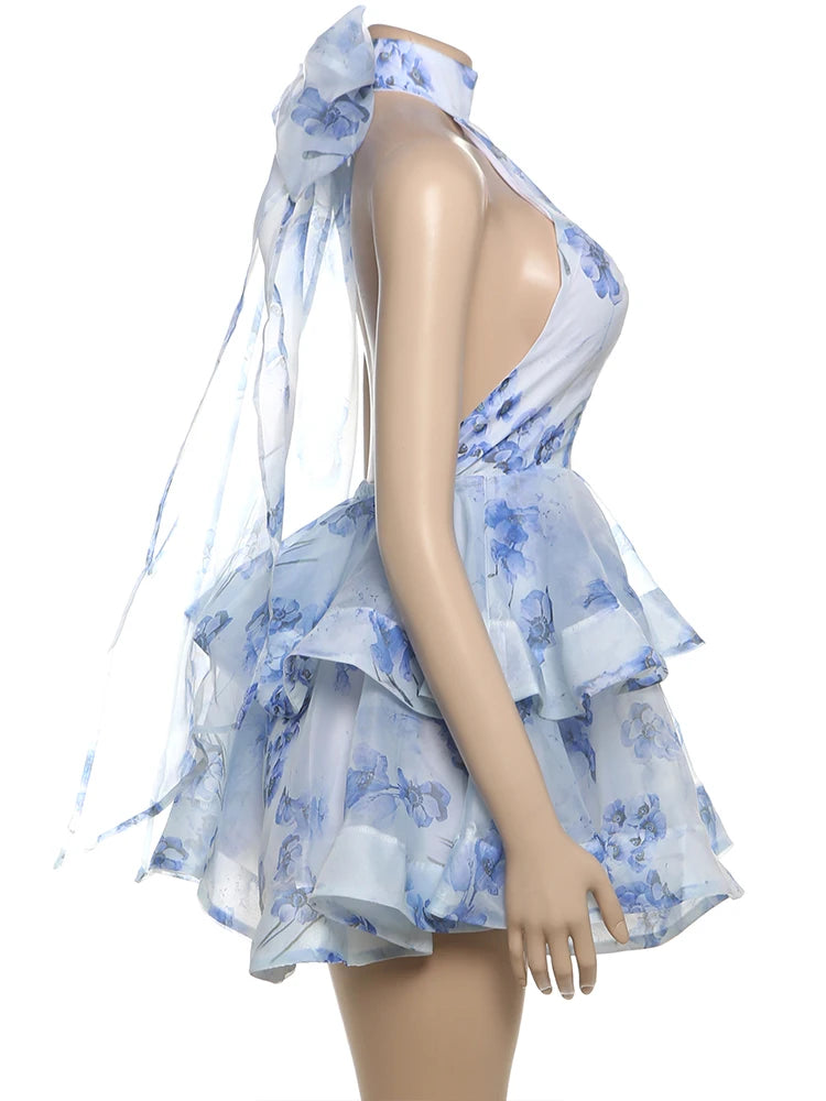 Mannequin wearing a blue floral dress with a white background