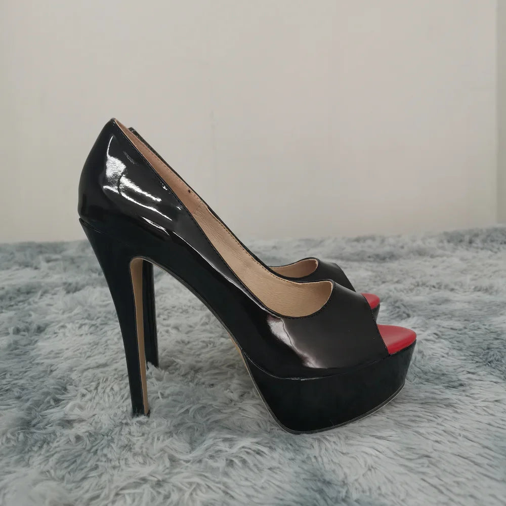 Black high-heeled platform shoes with red interior on a gray textured surface