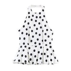 White dress with black polka dot pattern on a white background