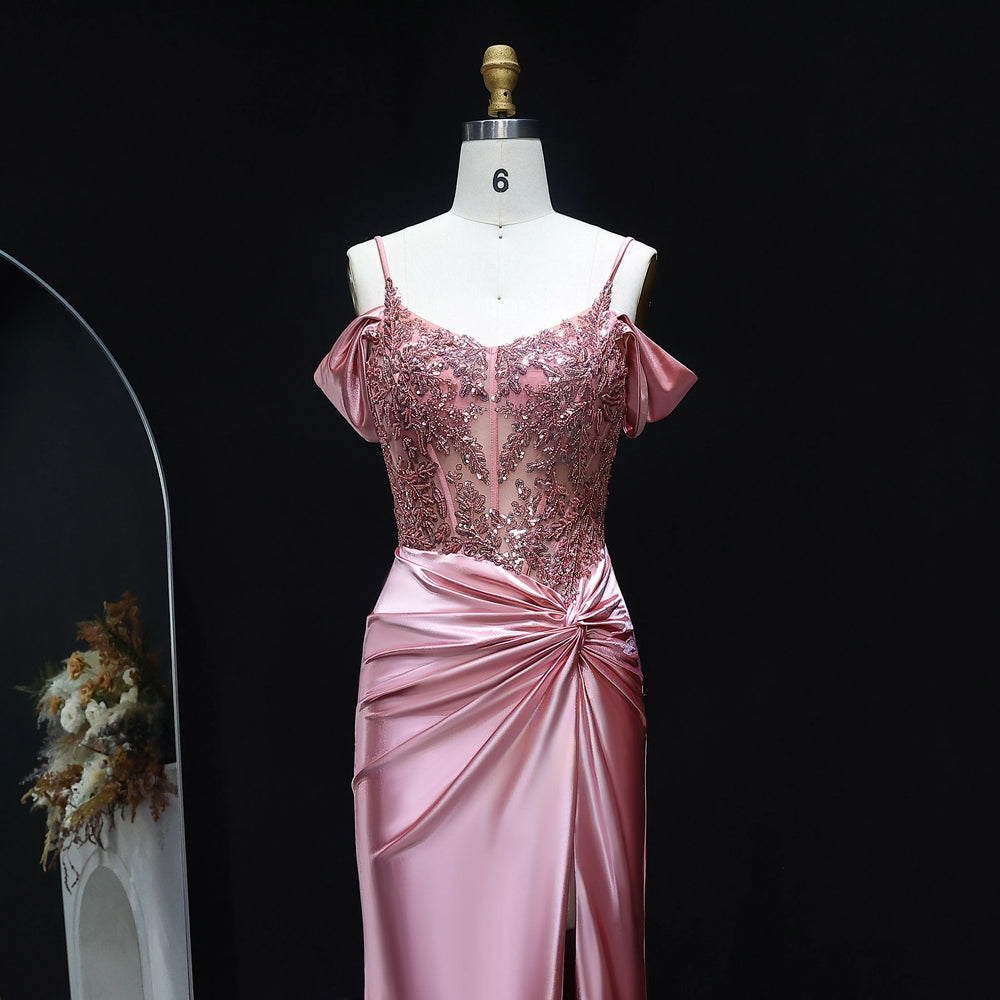 Pink evening gown on a mannequin against a black background