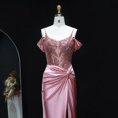 Pink evening gown on a mannequin against a black background