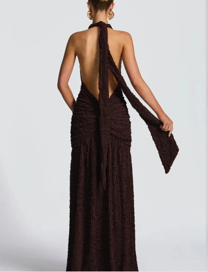 Brown halter neck dress with open back on a white background