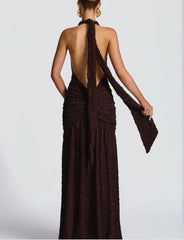 Brown halter neck dress with open back on a white background