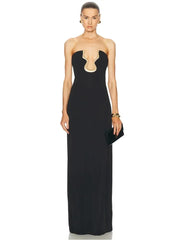 Model wearing a strapless black maxi dress with a gold neckline detail and clutch.