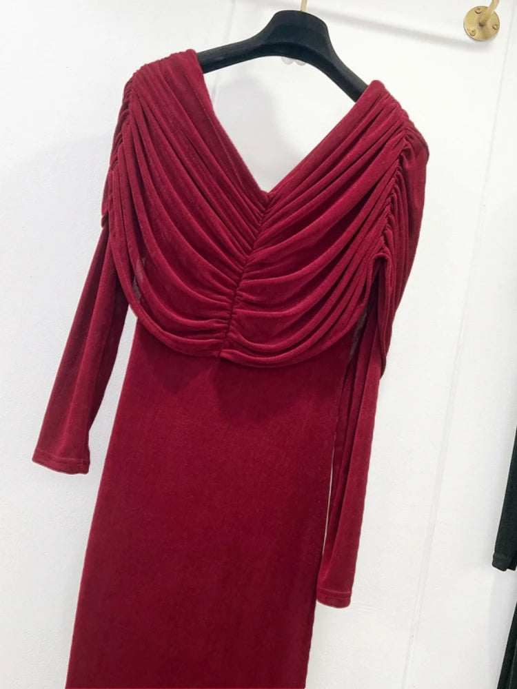 Red dress with a draped neckline on a hanger against a white background