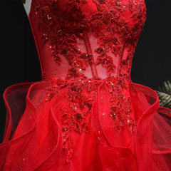 Red evening gown with intricate beadwork on a black background