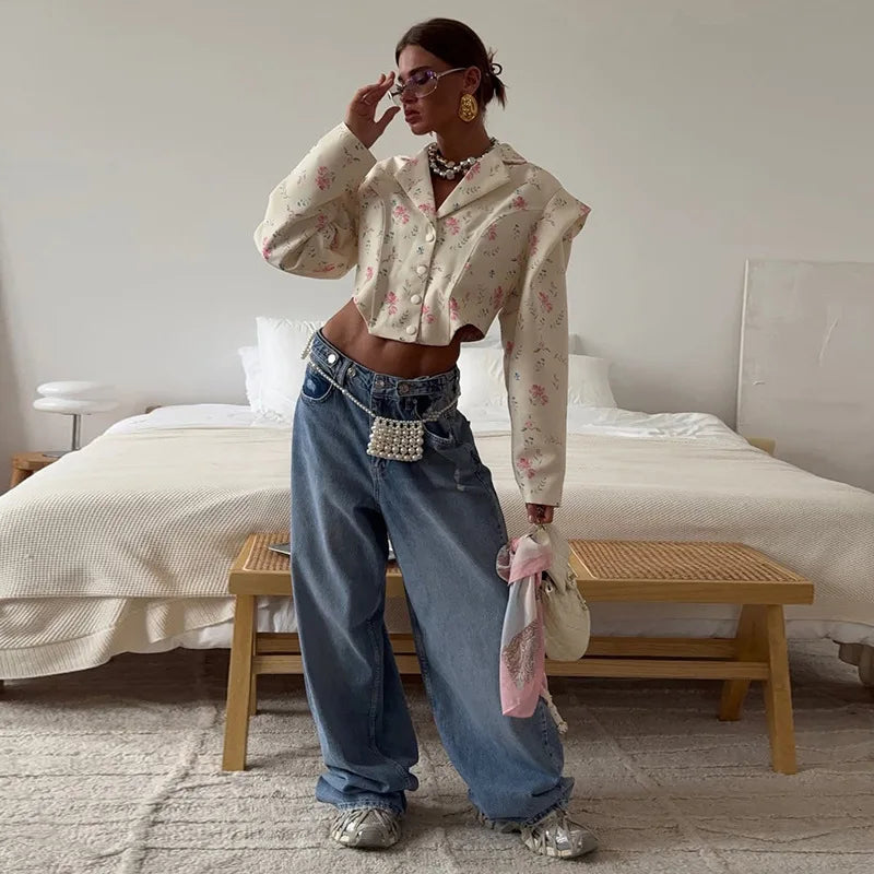 Woman in a stylish outfit standing in a bedroom