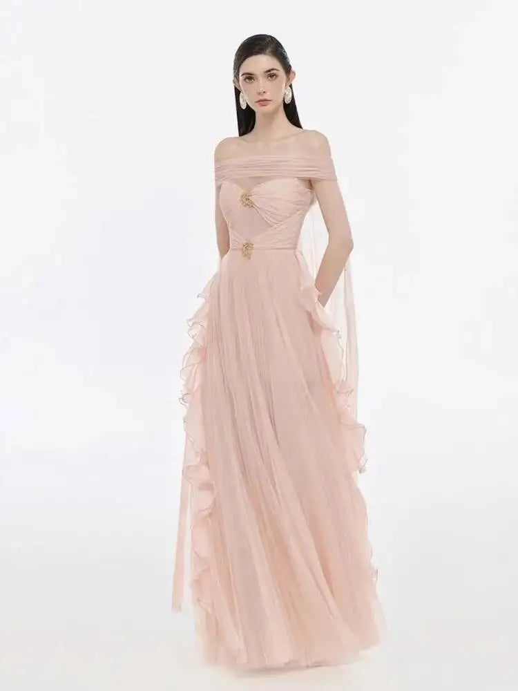 Model wearing an off-the-shoulder mesh evening gown