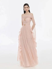 Model wearing an off-the-shoulder mesh evening gown