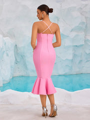 Woman wearing a pink dress with a textured blue and white background