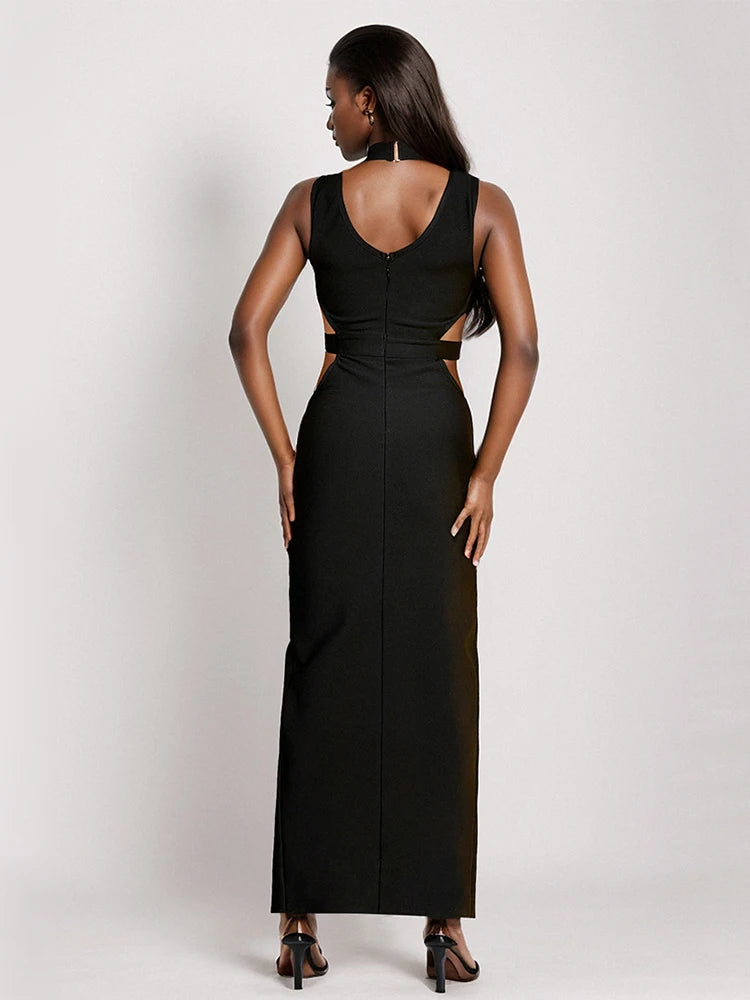 Woman wearing a black sleeveless gown with cut-out design on a white background