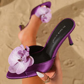 Purple orchid embellished satin stiletto heels on sand
