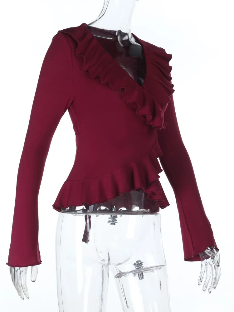 Red ruffled top on a mannequin with a white background