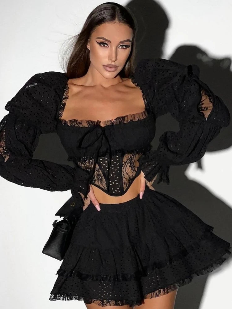 Woman wearing a black lace outfit with a white background