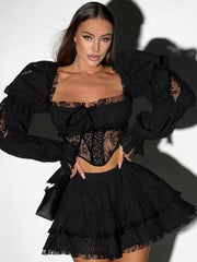 Woman wearing a black lace outfit with a white background