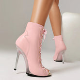 Pink high-heeled ankle boots with clear heel on a neutral background