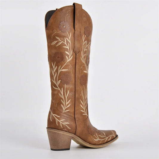 Brown cowboy boot with floral embroidery on a white background