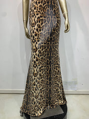 Leopard print evening gown on a mannequin against a white background