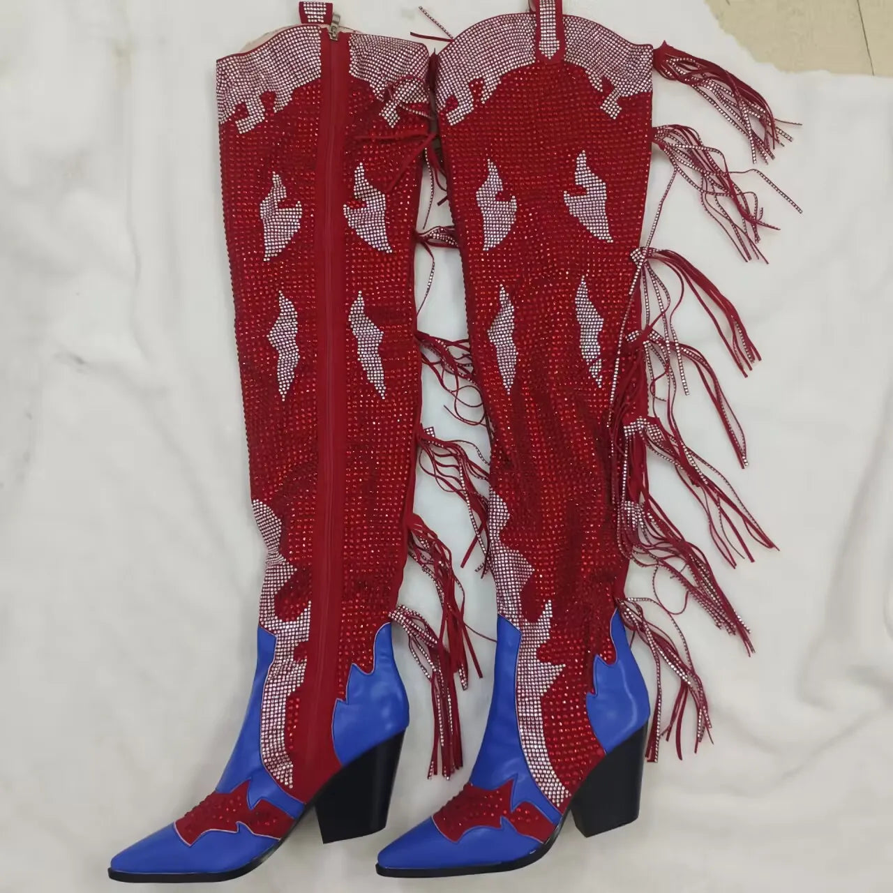 Red and blue knee-high boots with fringe details