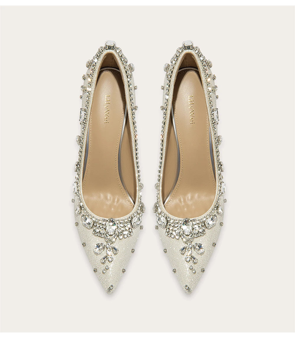 Pair of embellished white shoes on a light beige background