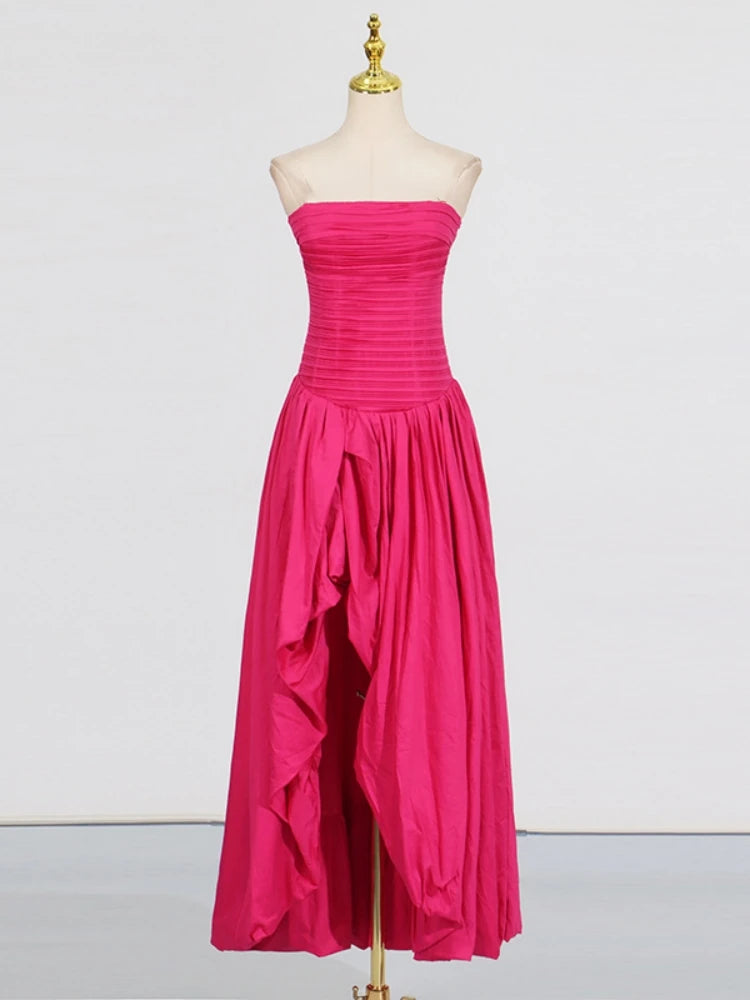 Pink strapless gown on a mannequin against a white background