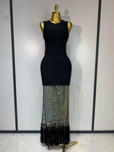 Black dress with a sheer, fringed bottom section on a mannequin against a white background