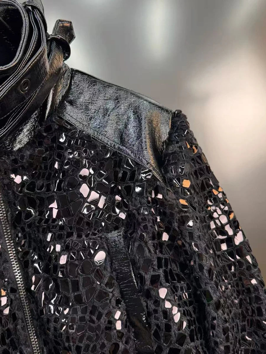 Black sequined jacket with a textured pattern on a neutral background