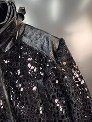 Black sequined jacket with a textured pattern on a neutral background