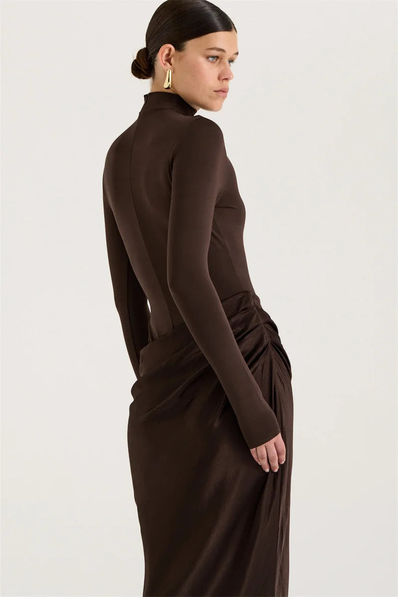 Woman wearing a brown dress with a high neckline on a white background
