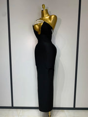 Black evening gown on a mannequin against a white wall with black vertical stripes.