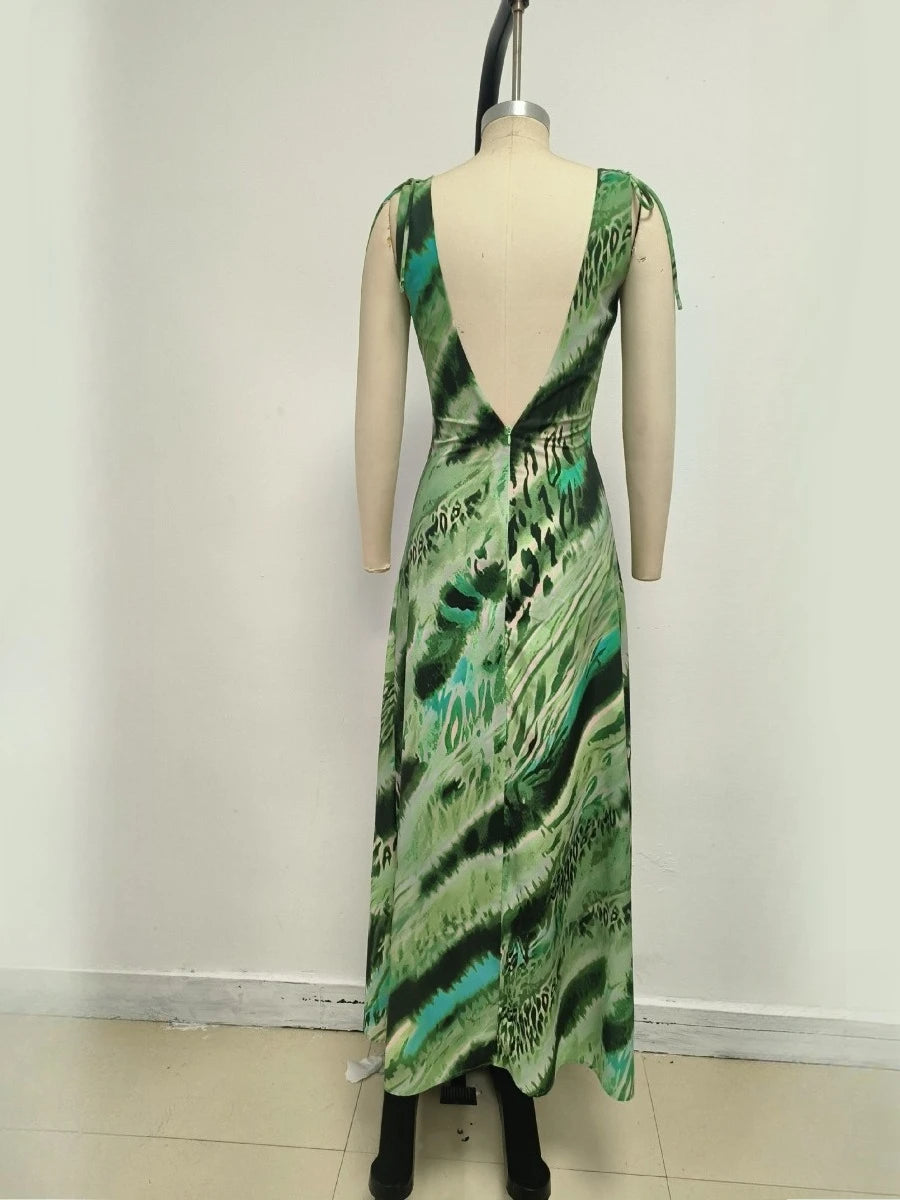 Green patterned dress on a mannequin against a white wall