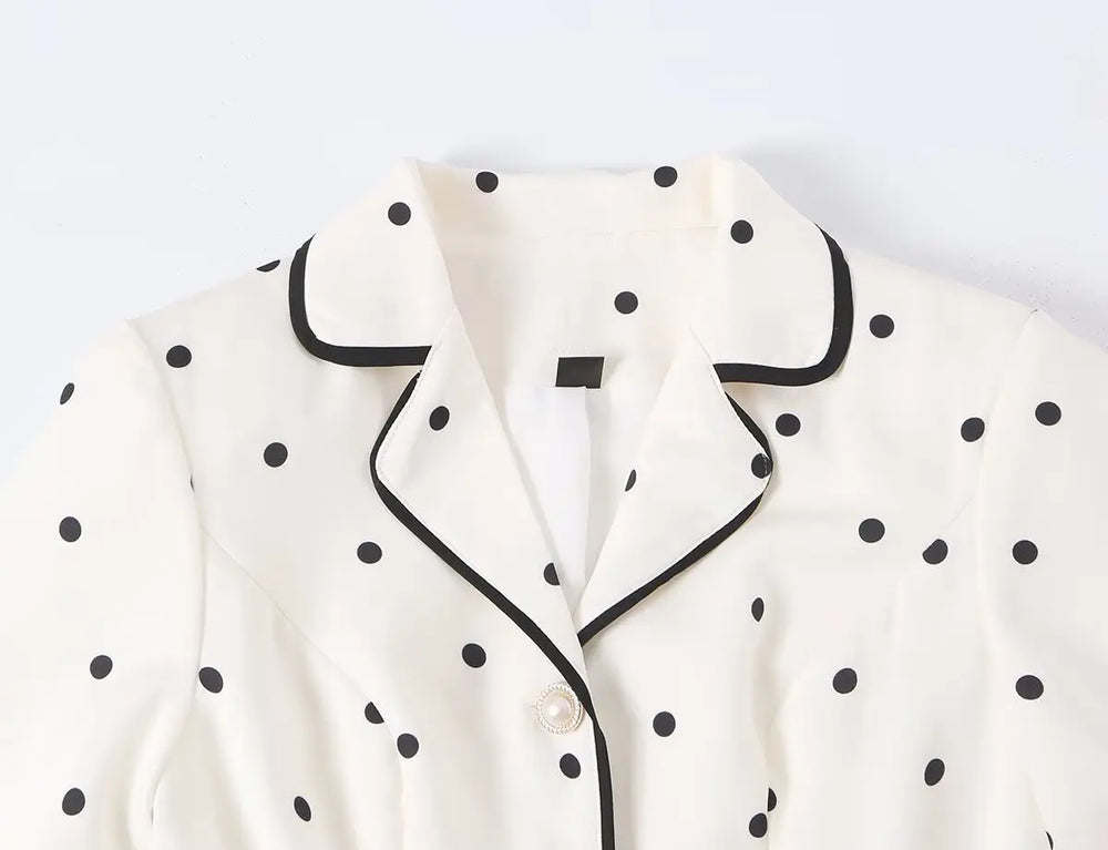 Close-up of the polka dot notched collar coat neckline