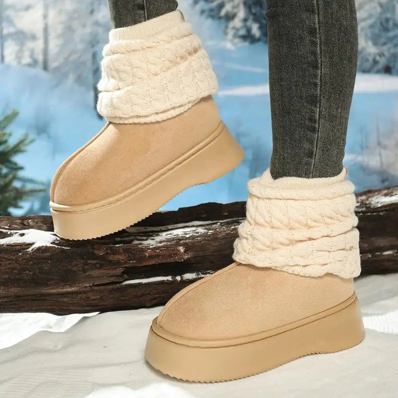 Tan winter boots with white fur trim worn by a person standing on a snowy ground.