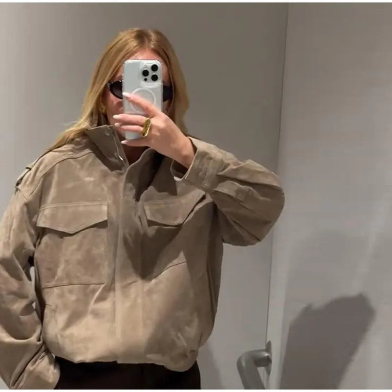 Stand collar suede bomber jacket detail on a person